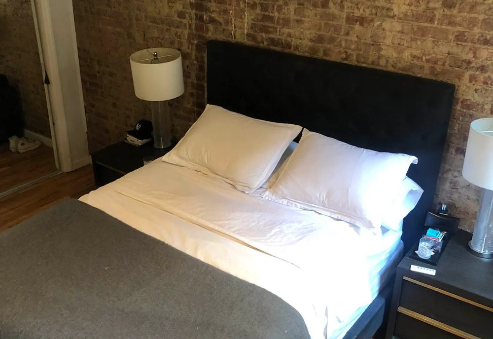 Renovated bedroom with exposed brick at 343 East 66th Street